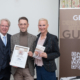 Willy Lehmann (Herausgeber Genuss Guide und Moderator), Christoph Frierss (Top-Empfehlung, Kat. Fleisch & Wurst: FRIERSS FEINES HAUS), Andrea Knura (Autorin und Herausgeberin Genuss Guide, v.l.)